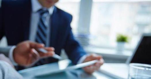 businessman in office with papers